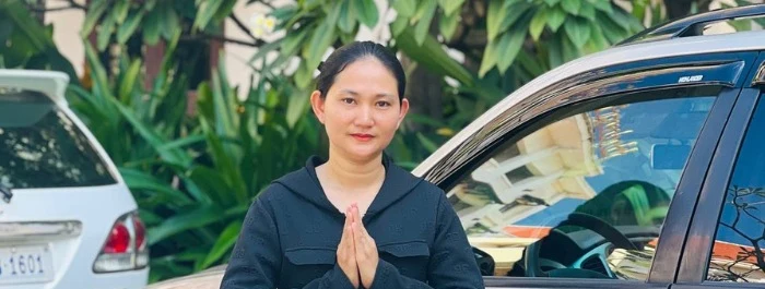 An Angkor Lady driver greeting a guest with a traditional sampeah