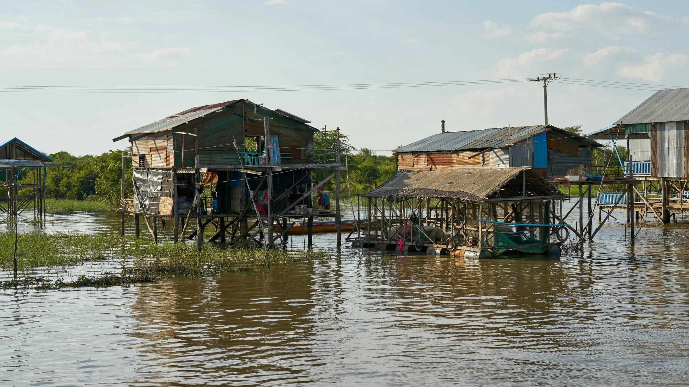 Stilted homes rising from the flooded waters of Kampong Khleang